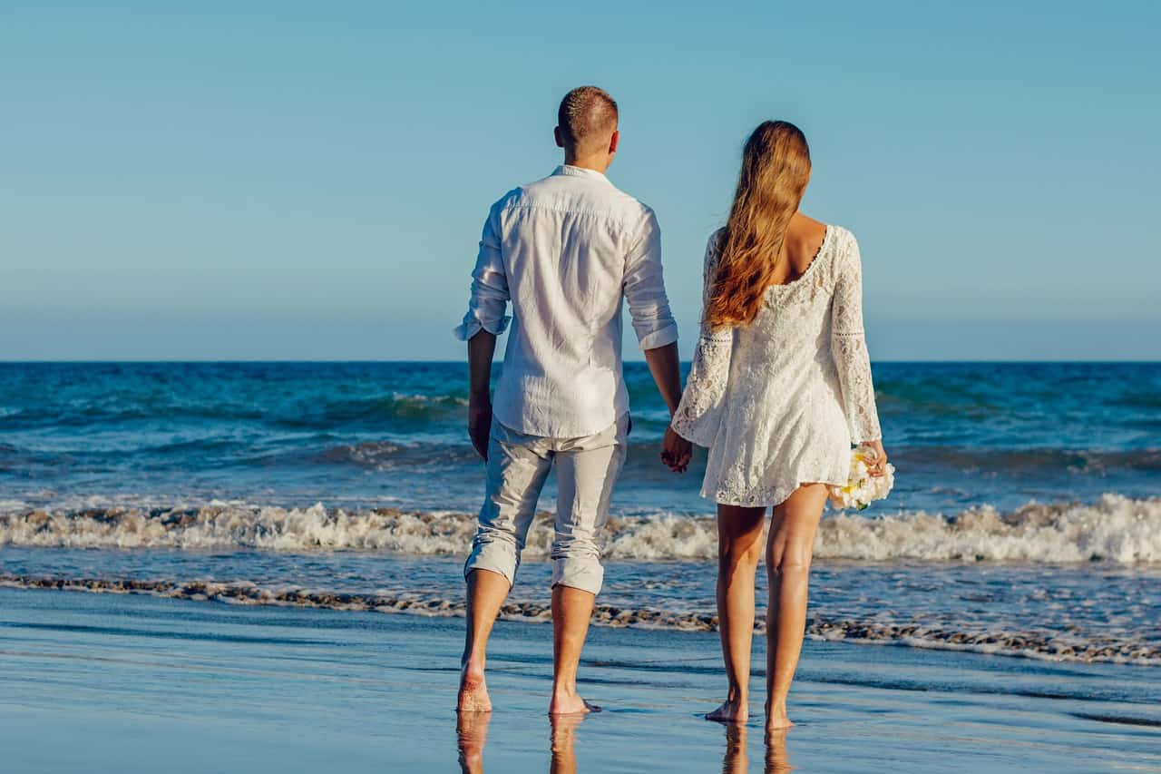 Husband and wife walking on the beach