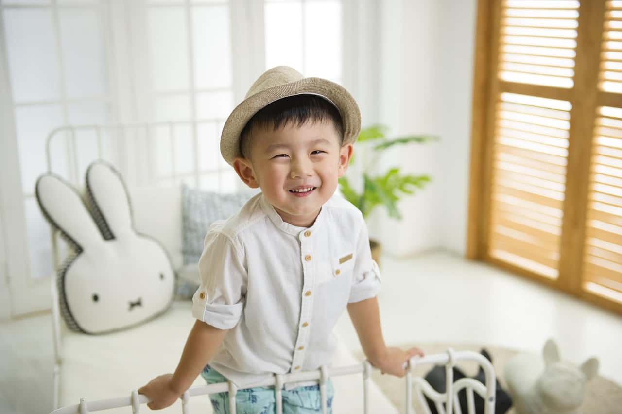 a little boy standing and laughing