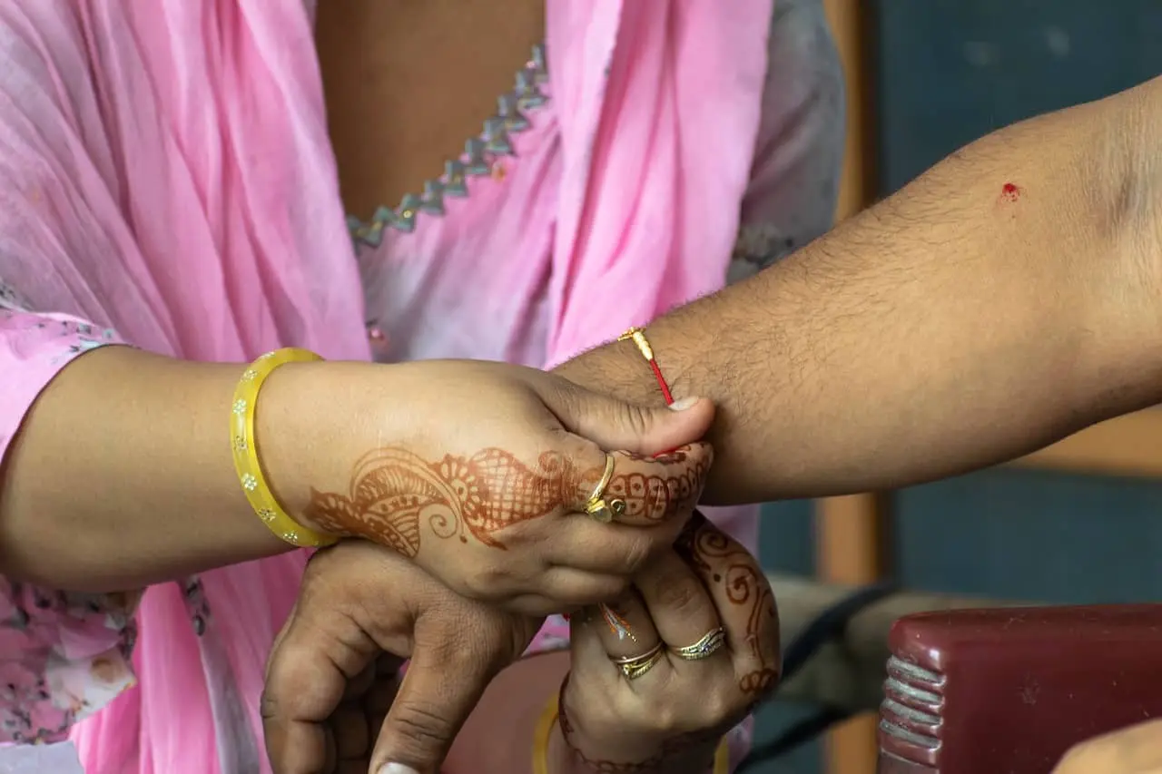 A sister tying a rakhi to her brother
