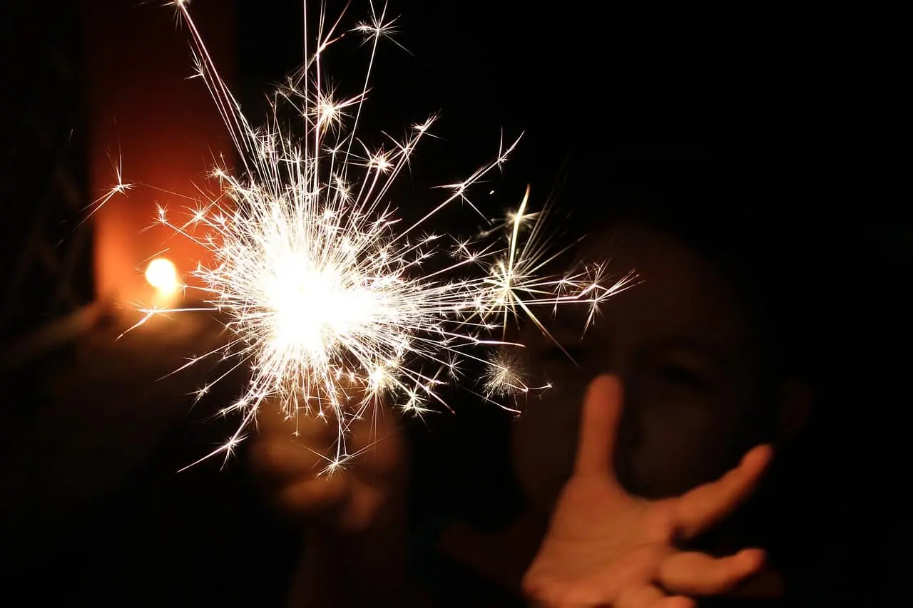 a boy lighting a sparkler